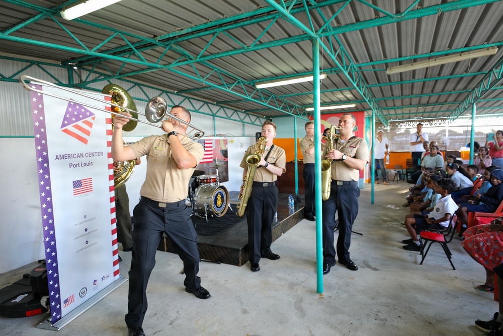 Members of the U.S. Naval Forces Europe and Africa Band (Topside Brass Band) perform for students and teachers at Vent d'un Rêve