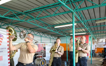 Members of the U.S. Naval Forces Europe and Africa Band (Topside Brass Band) perform for students and teachers at Vent d'un Rêve
