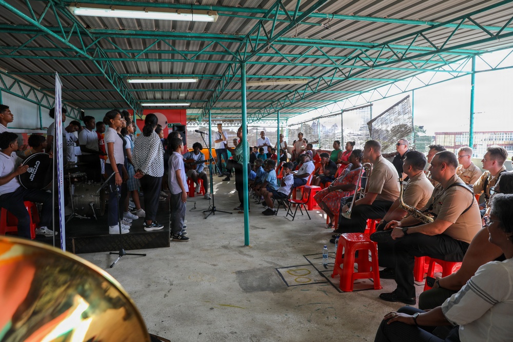 U.S. Naval Forces Europe and Africa Band (Topside Brass Band) perform for students and teachers at Vent d'un Rêve