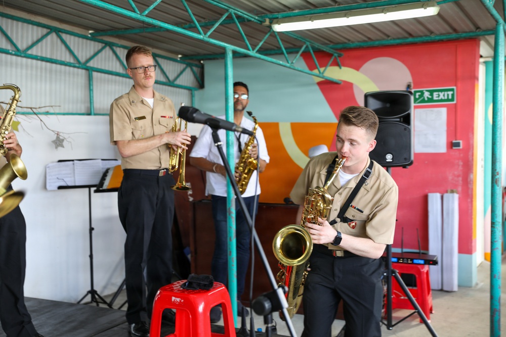 U.S. Naval Forces Europe and Africa Band (Topside Brass Band) perform for students and teachers at Vent d'un Rêve