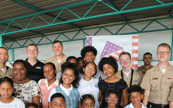 U.S. Naval Forces Europe and Africa Band (Topside Brass Band) perform for students and teachers at Vent d'un Rêve