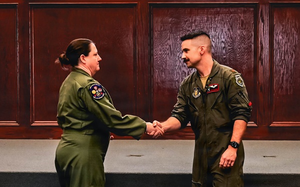 513th ACG Commander Coins Airman for Distinguished Support