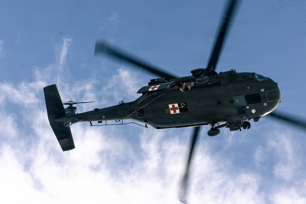 U.S. service members practice joint-service casualty evacuation drills during Mountain Medicine Course 1-26