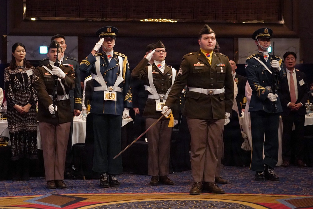 Combined color guard stands at attention