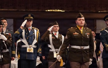 Combined color guard stands at attention