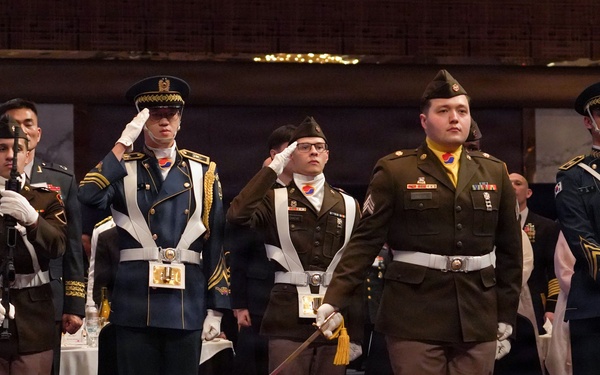Combined color guard stands at attention