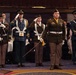 Combined color guard stands at attention