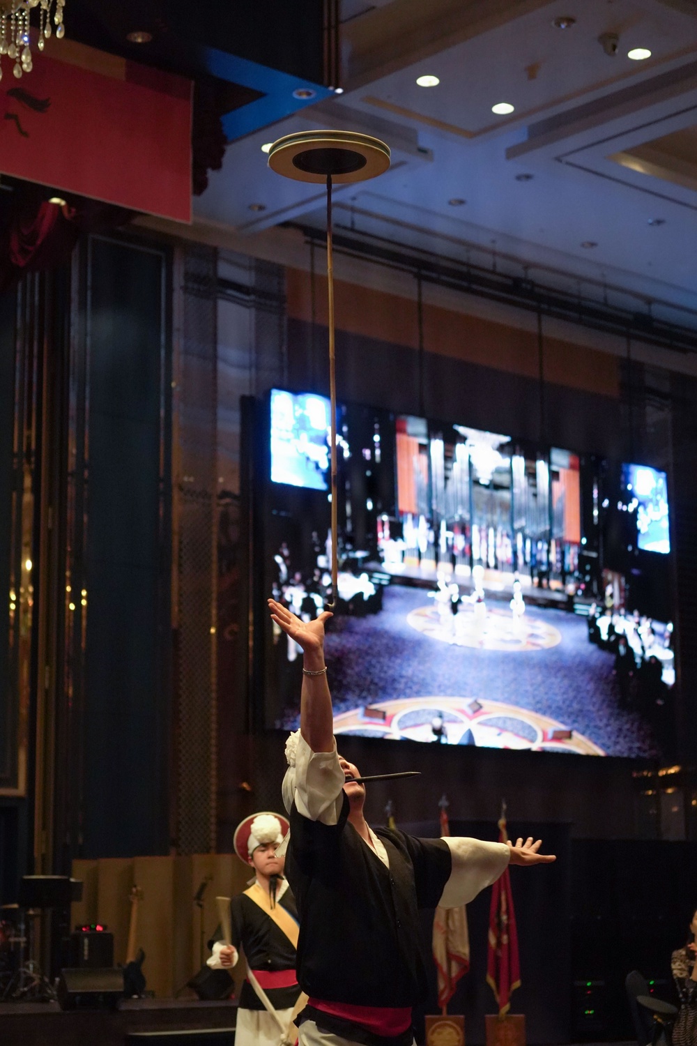 Performer balances spinning plate during celebration