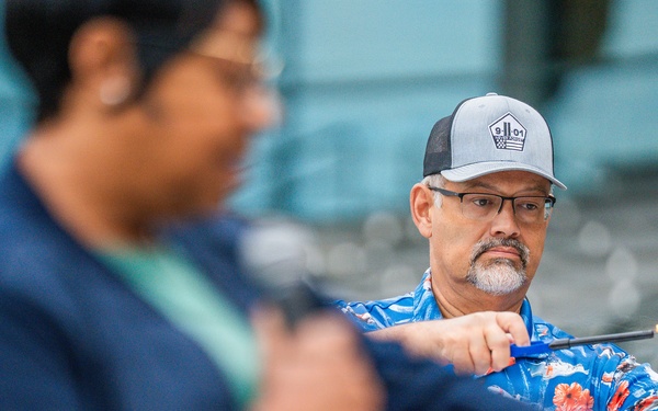 A Coast Guard Civilian lights a candle in rememberance of the victims of 9/11