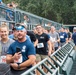 A line of participants weave in and out of the bleacher stairs