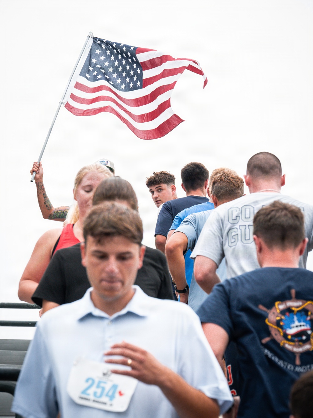 The American flag waves while members climb the 110 flights of stairs