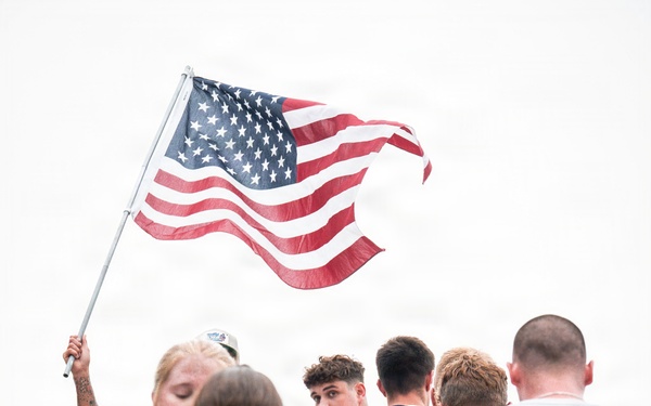 The American flag waves while members climb the 110 flights of stairs