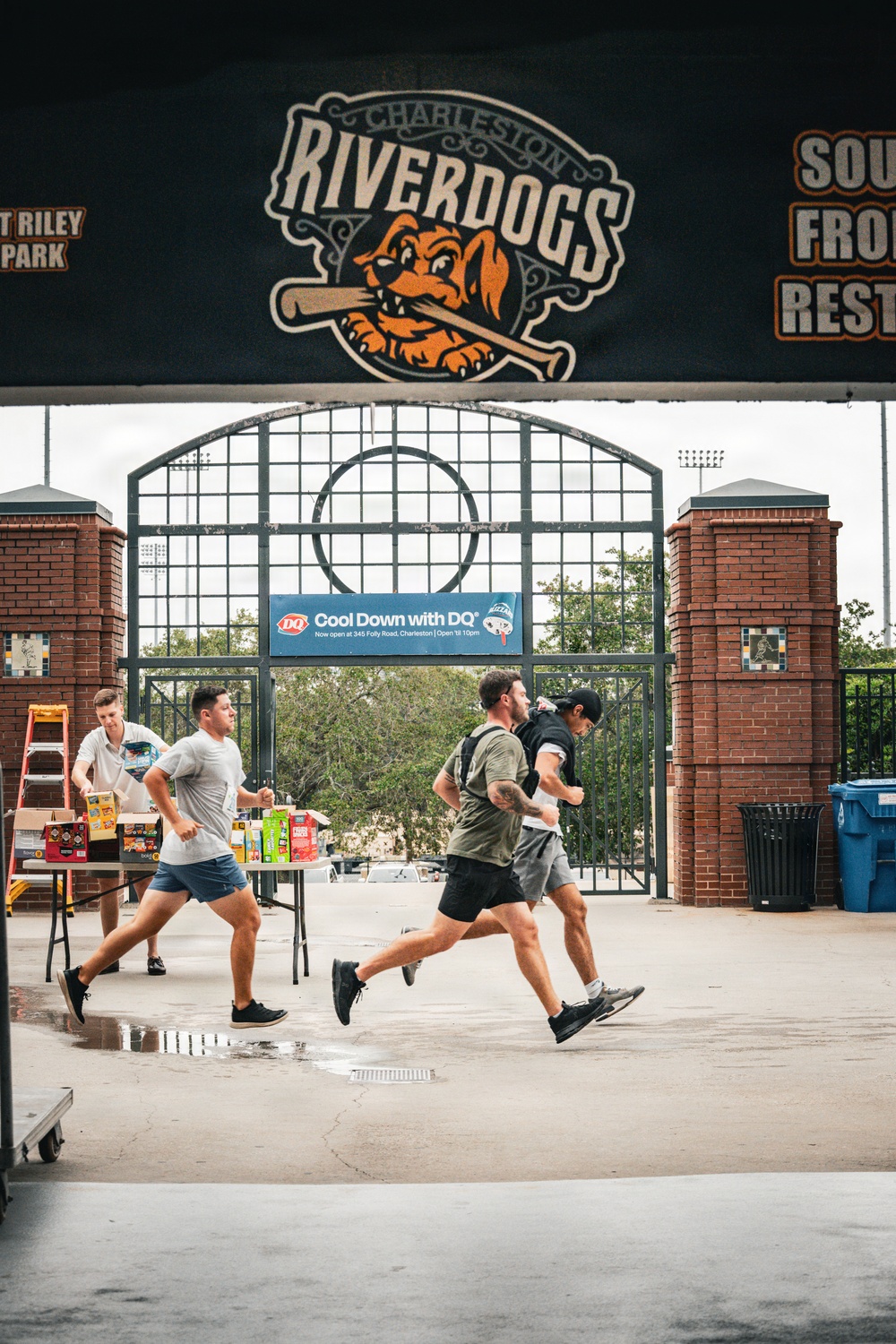 Participants run along the concorse of the Charleston RiverDogs stadium