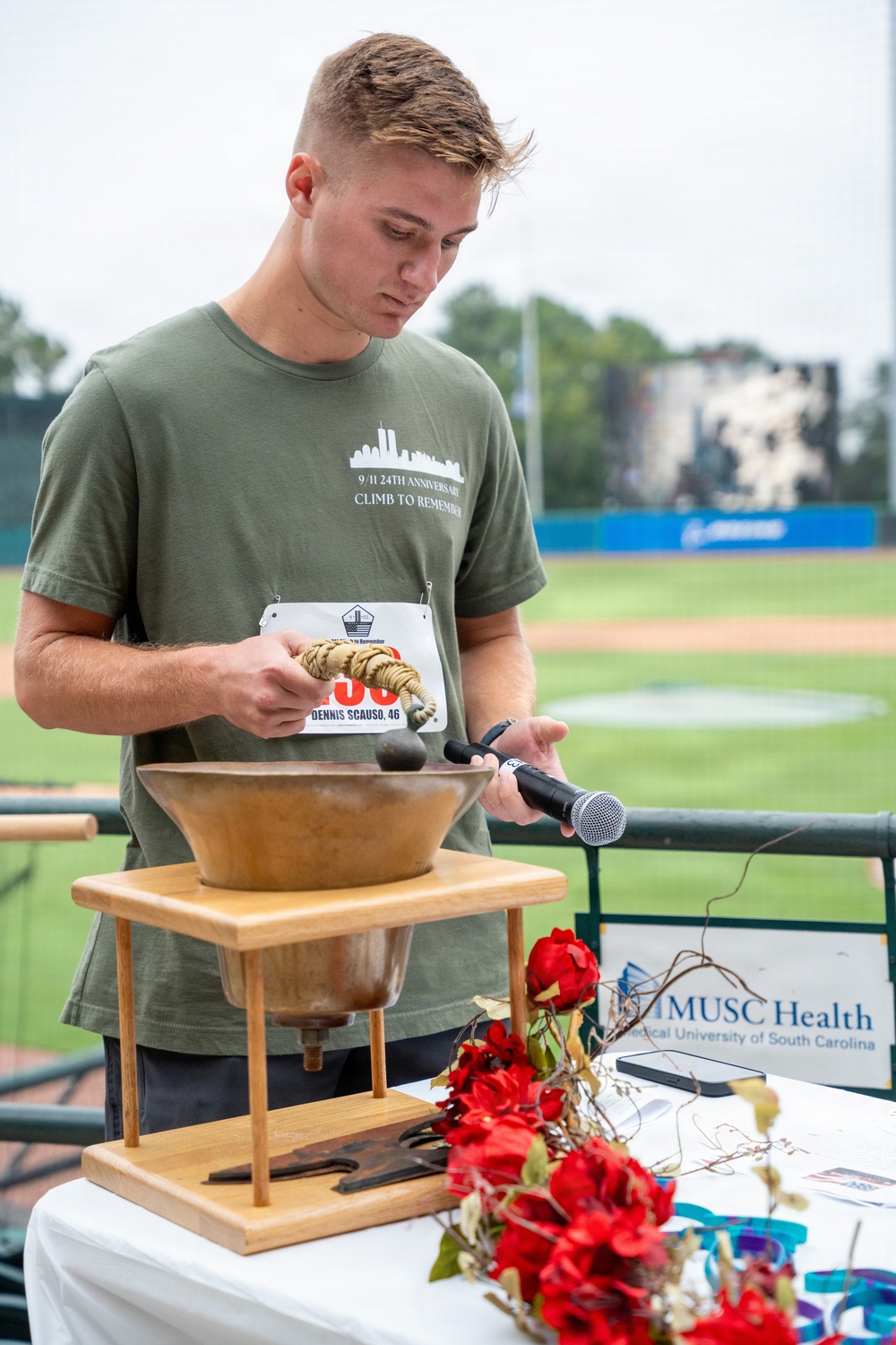The event MC rings the bell for a moment of silence.