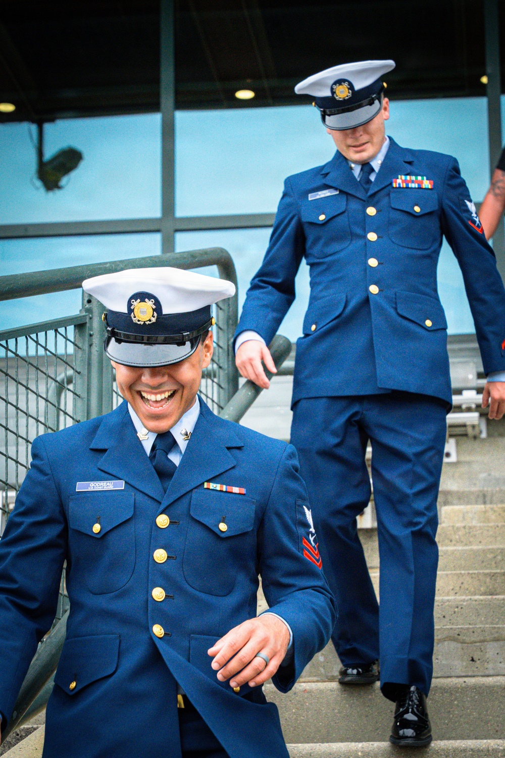 Coast Guard members smiling during the 110 flight climb