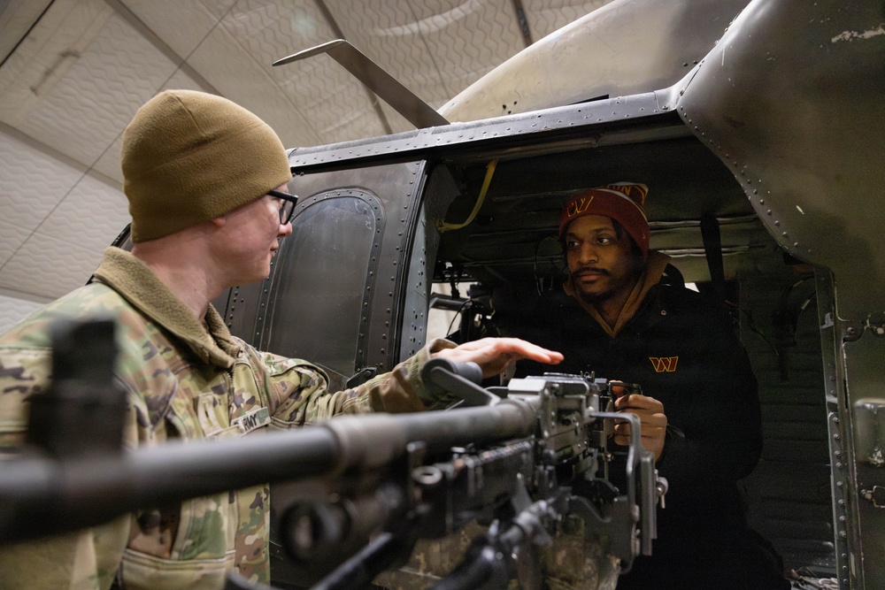 NFL Cheerleader Receives a Tour of a Helicopter