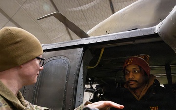 NFL Cheerleader Receives a Tour of a Helicopter