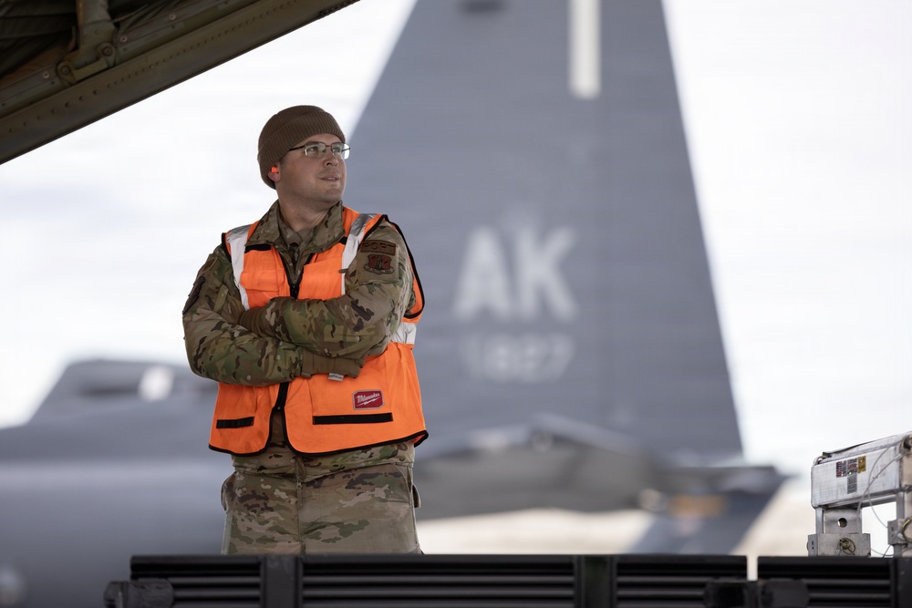 176th Wing air transportation specialists and loadmasters work together
