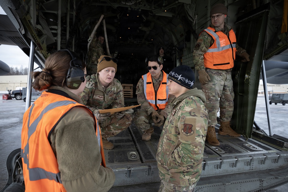 176th Wing air transportation specialists and loadmasters work together