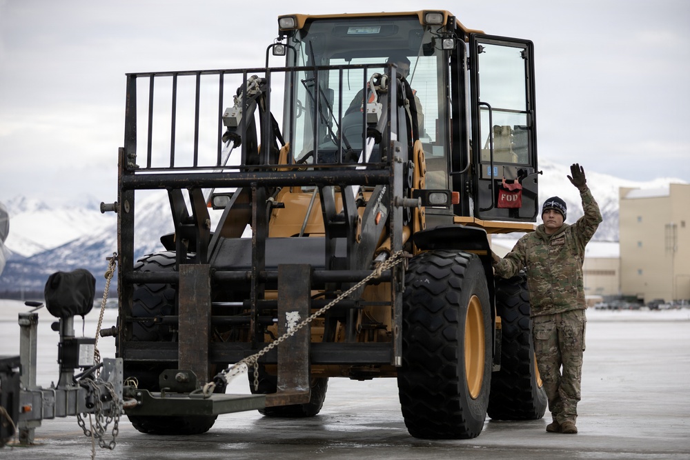 176th Wing air transportation specialists and loadmasters work together