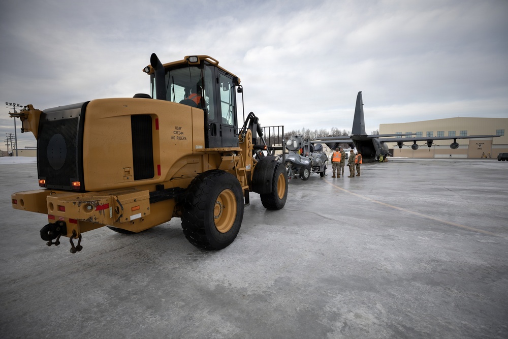 176th Wing air transportation specialists and loadmasters work together