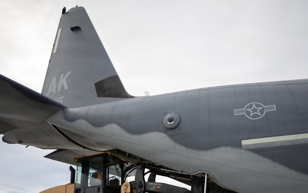 176th Wing air transportation specialists and loadmasters work together