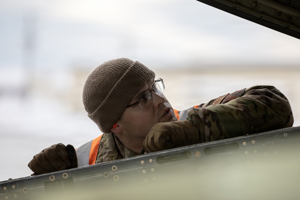 176th Wing air transportation specialists and loadmasters work together