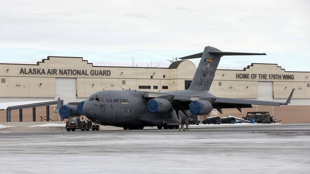 176th Wing air transportation specialists and loadmasters work together