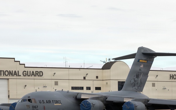 176th Wing air transportation specialists and loadmasters work together
