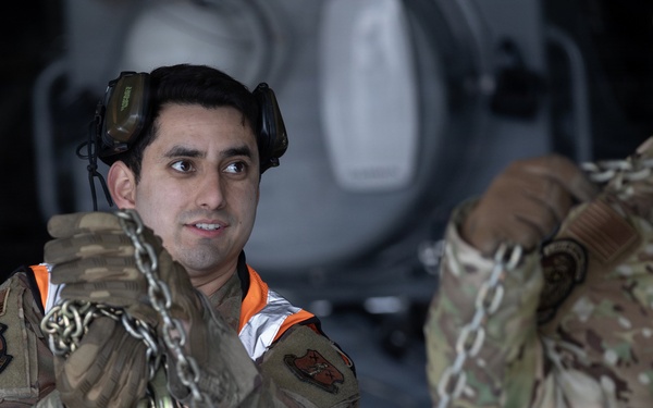 176th Wing air transportation specialists and loadmasters work together
