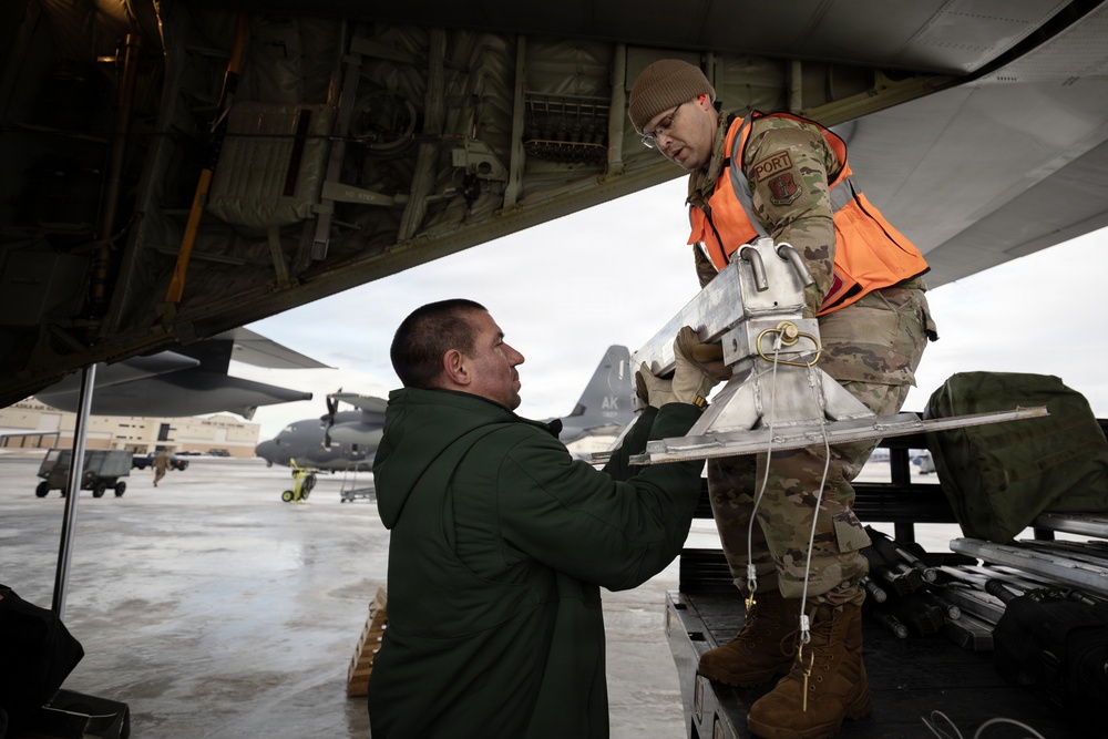 176th Wing air transportation specialists and loadmasters work together