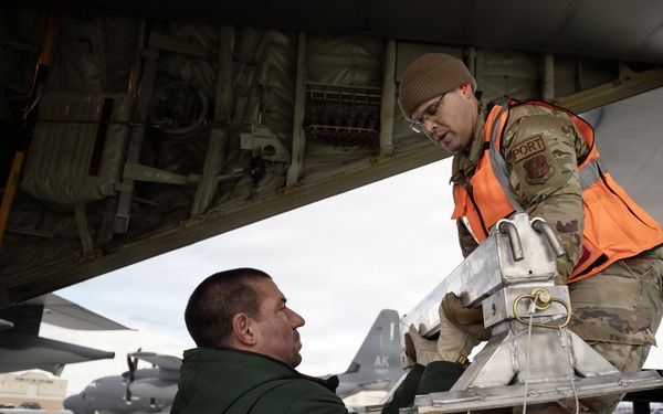 176th Wing air transportation specialists and loadmasters work together