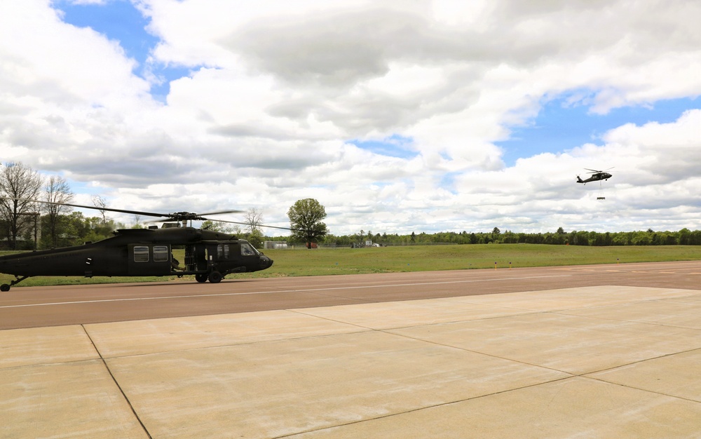 Soldiers with 13th Battalion, 100th Regiment hold slingload training at McCoy; Wisconsin National Guard Black Hawks, crews assist