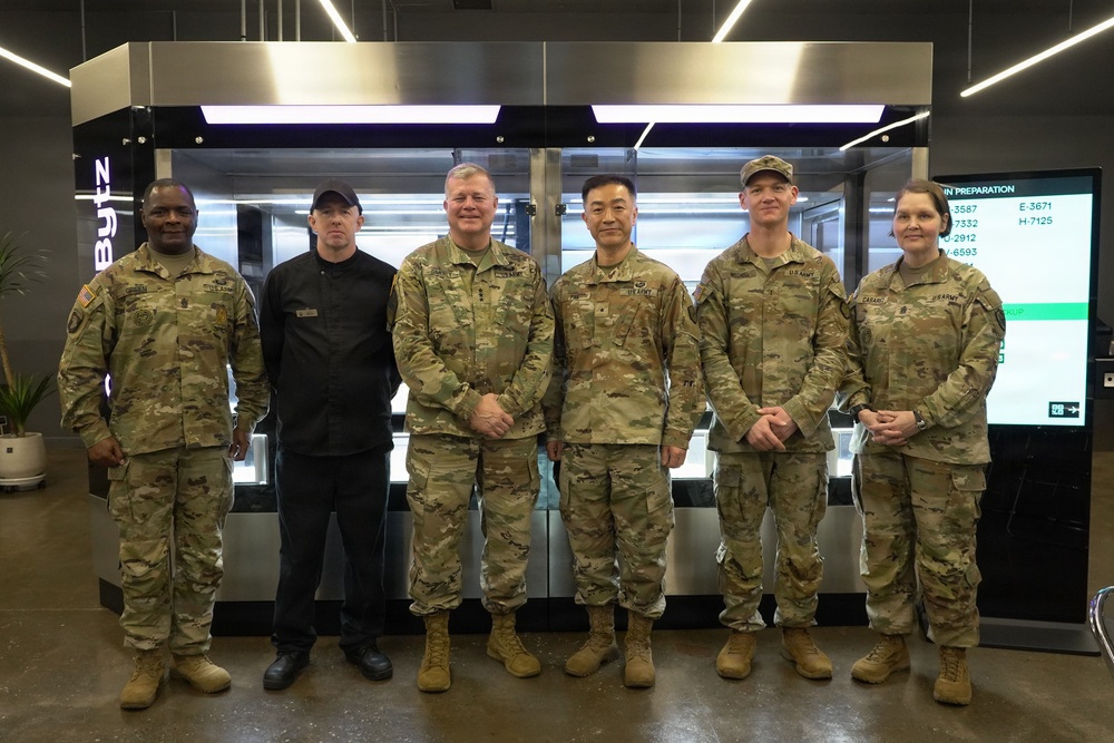 Senior leaders pose inside Camp Walker’s Autonomous Kitchen
