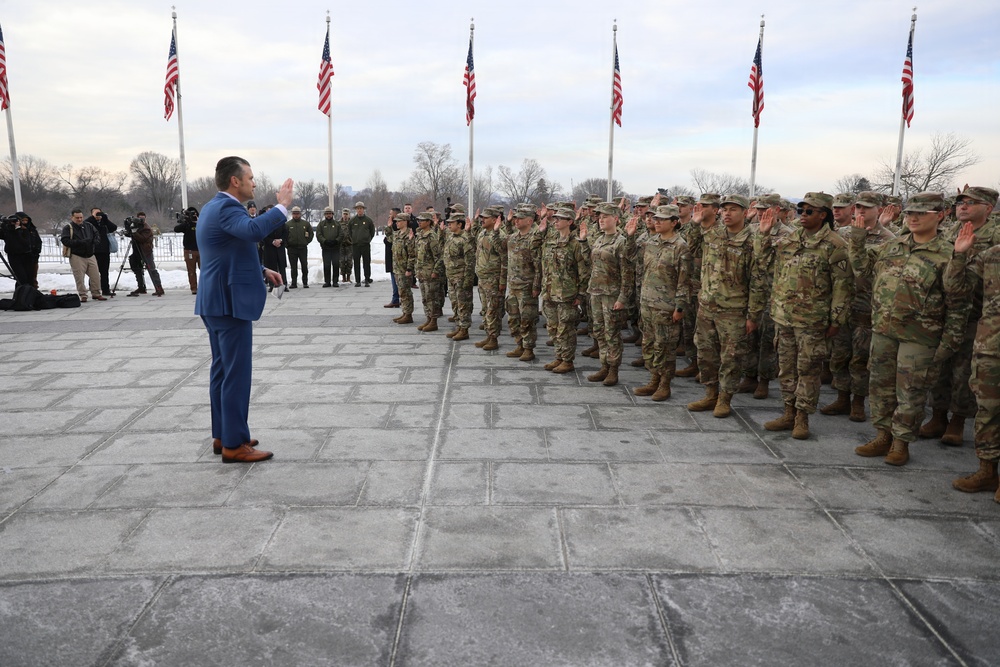 Secretary of War Pete Hegseth officiates the oath of enlistment to a formation of National Guard Soldiers