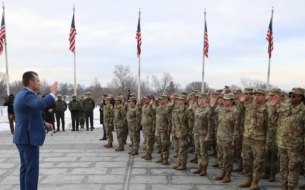 Secretary of War Pete Hegseth officiates the oath of enlistment to a formation of National Guard Soldiers