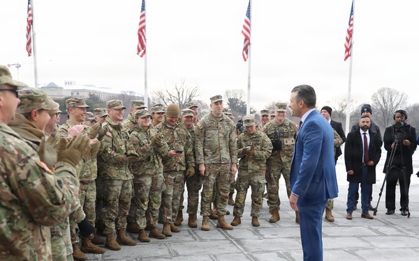 Secretary of War Pete Hegseth officiates the oath of enlistment to a formation of National Guard Soldiers