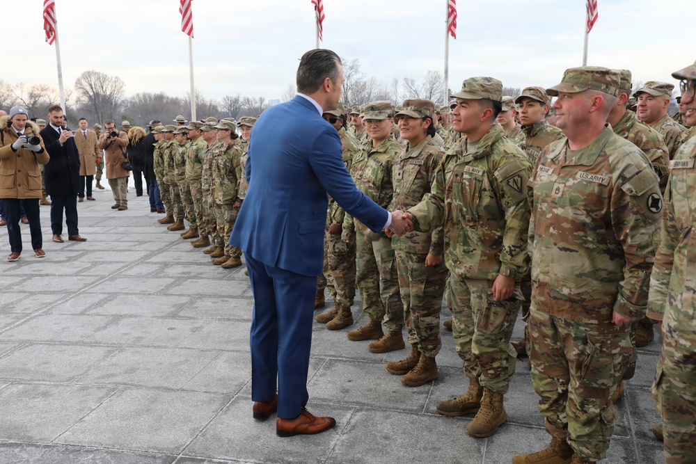 Secretary of War Pete Hegseth officiates the oath of enlistment to a formation of National Guard Soldiers
