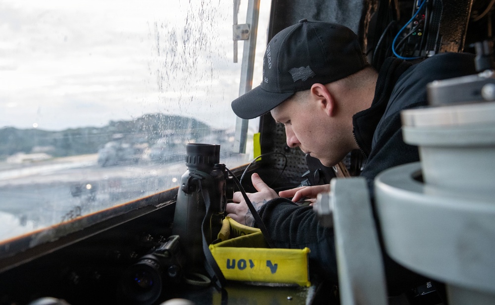 Sailor Prepares Equiptment in Pilothouse