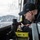 Sailor Prepares Equiptment in Pilothouse