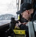 Sailor Prepares Equiptment in Pilothouse