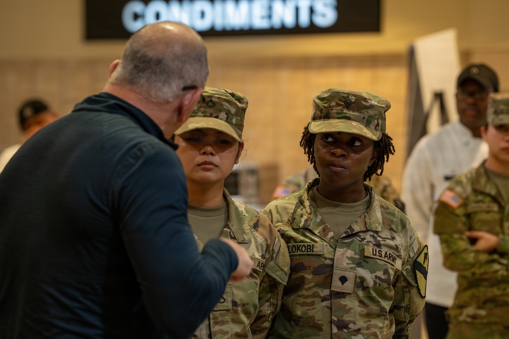 Chef Robert Irvine Reviews Dishes Prepared by 92G Soldiers