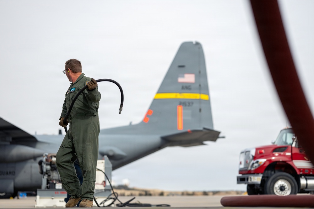 153rd Airlift Wing Airman Carries Air Hose for MAFFS Test