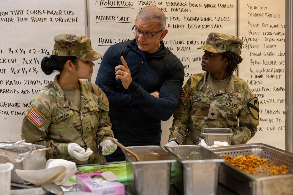 Chef Robert Irvine Reviews Dishes Prepared by 92G Soldiers
