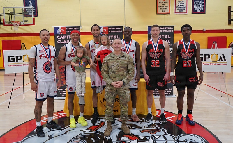 Col. Keith Sandoval, Commander of Joint Base Myer Hall, poses with awardees following the Capital Classic Basketball Tournament.