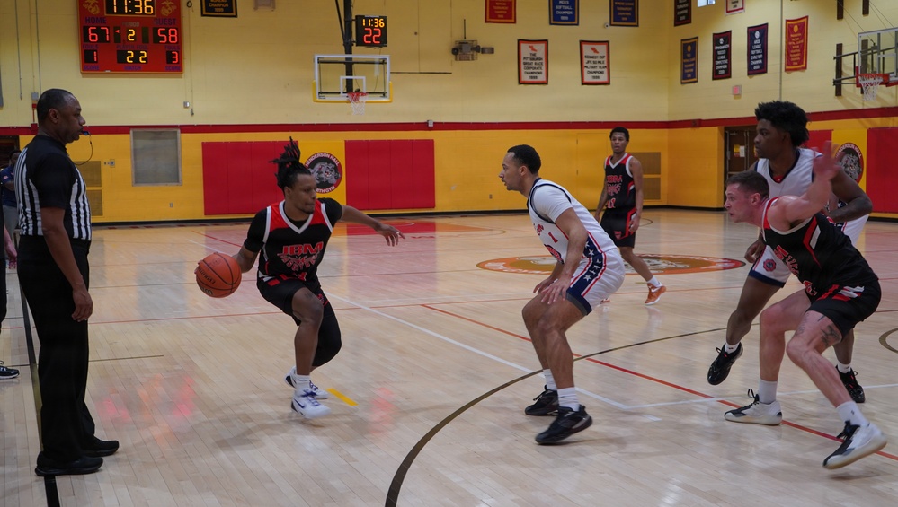 A member of team Fort Sam Houston defends the rim during the Capital Classic Basketball Tournament.