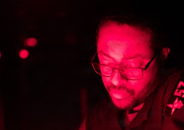 USS Mitscher (DDG 57) Sailor stands watch in ship bridge