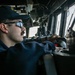 USS Mitscher (DDG 57) junior officer stands watch in ship bridge