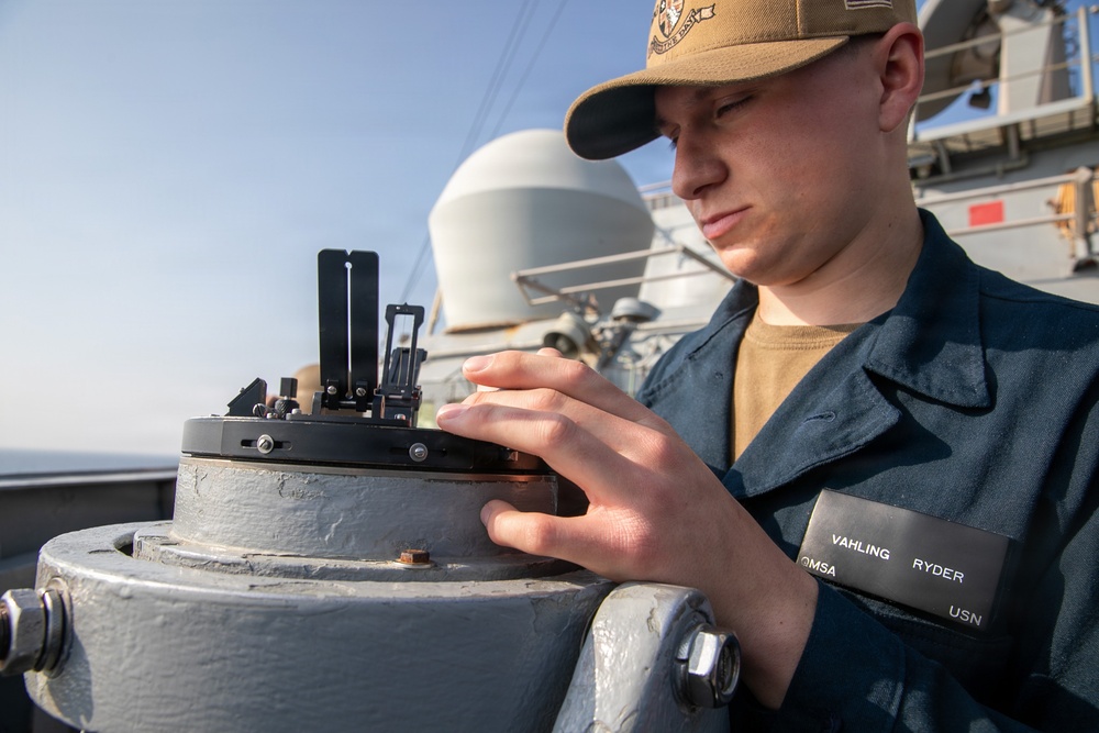 USS Mitscher (DDG 57) Sailor conducts maintenance on bridge wing compass