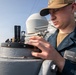 USS Mitscher (DDG 57) Sailor conducts maintenance on bridge wing compass
